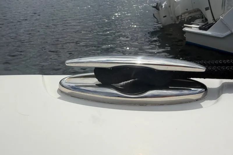 Slide: The Image of Stainless steel cleat on 2019 Sailfish 245 DC boat, docked by the water. - 14