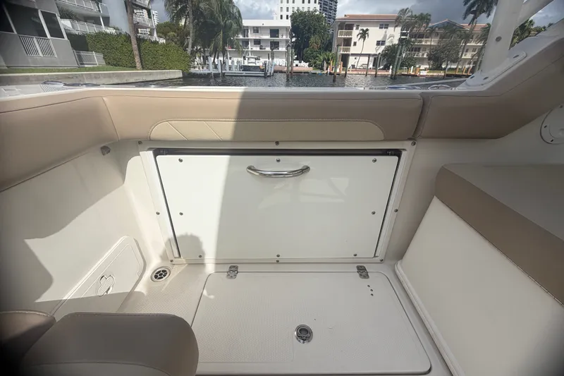 Slide: The Image of Interior view of a 2019 Sailfish 245 DC boat, featuring seating and storage compartments. - 34