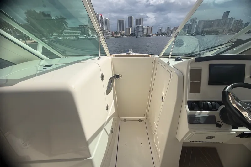Slide: The Image of 2019 Sailfish 245 DC boat interior with city skyline view. - 26
