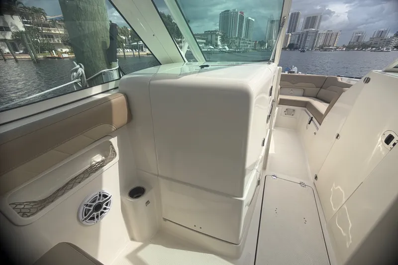 Slide: The Image of Interior view of a 2019 Sailfish 245 DC boat with seating and water view. - 24