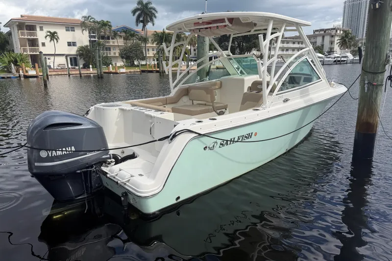 The Image of 2019 Sailfish 245 DC boat docked with Yamaha outboard motor in a marina setting. - 1