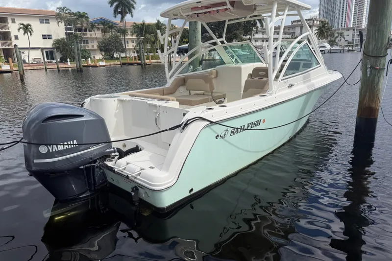 Slide: The Image of 2019 Sailfish 245 DC boat docked with Yamaha outboard motor. - 3