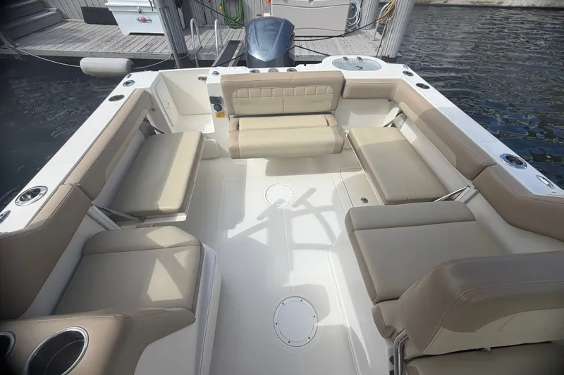Slide: The Image of 2019 Sailfish 245 DC boat interior with beige seating and cup holders. - 36