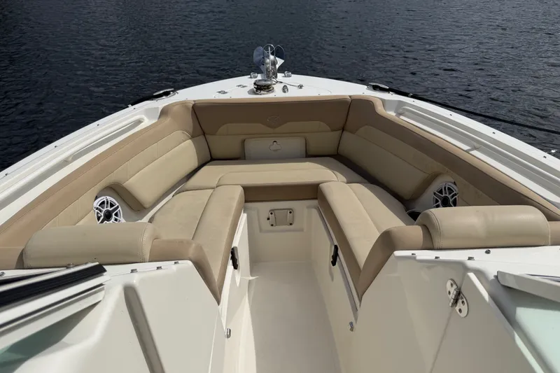 Slide: The Image of 2019 Sailfish 245 DC boat interior with beige seating and water view. - 15