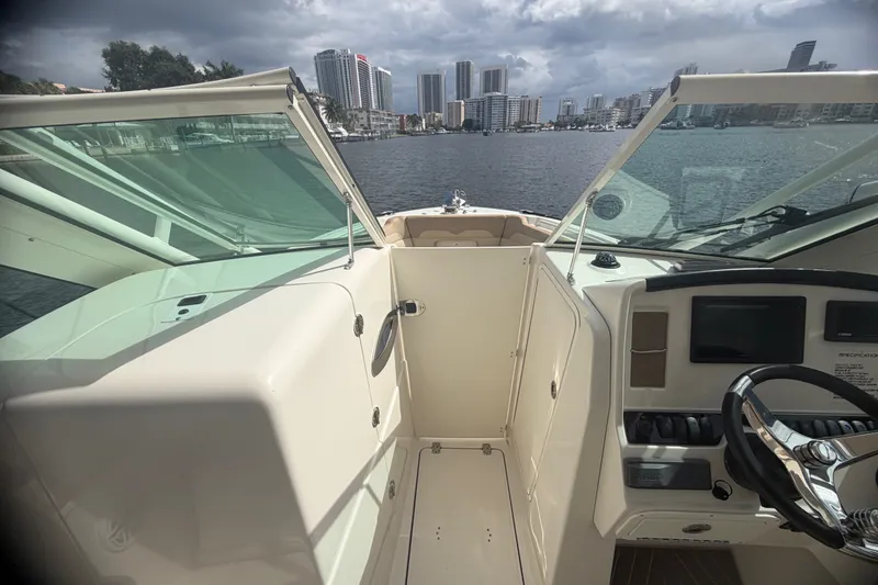 Slide: The Image of 2019 Sailfish 245 DC boat interior with city skyline in the background. - 25