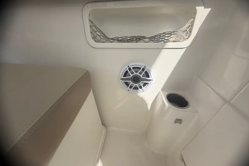 Slide: The Image of Interior of 2019 Sailfish 245 DC boat with speaker, cup holder, and storage net. - 29