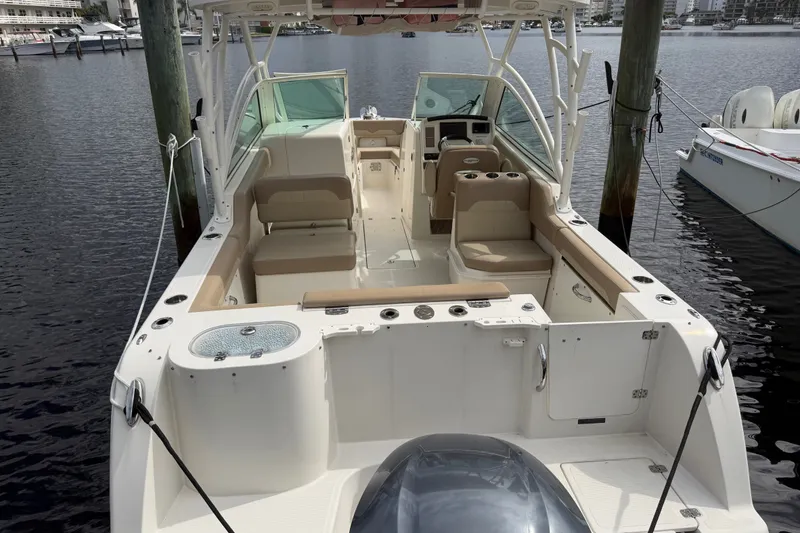 Slide: The Image of 2019 Sailfish 245 DC boat interior with seating, docked at marina. - 7