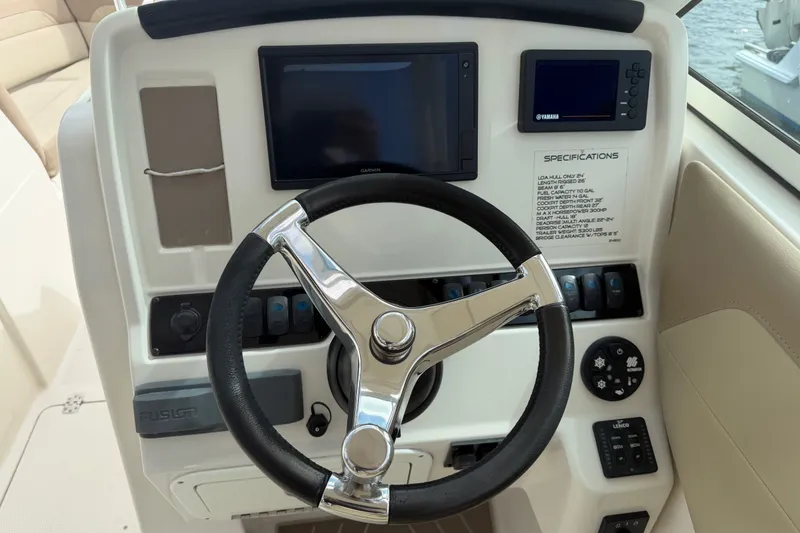 Slide: The Image of Steering console of 2019 Sailfish 245 DC boat with navigation screens and controls. - 16