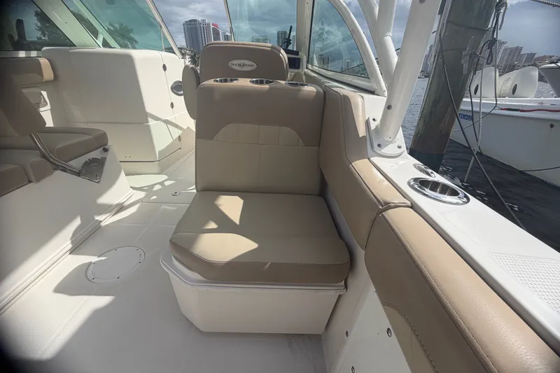 Slide: The Image of 2019 Sailfish 245 DC boat interior with beige seating and cup holders. - 32