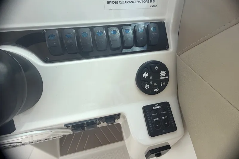 Slide: The Image of Control panel of a 2019 Sailfish 245 DC boat with switches and buttons. - 20