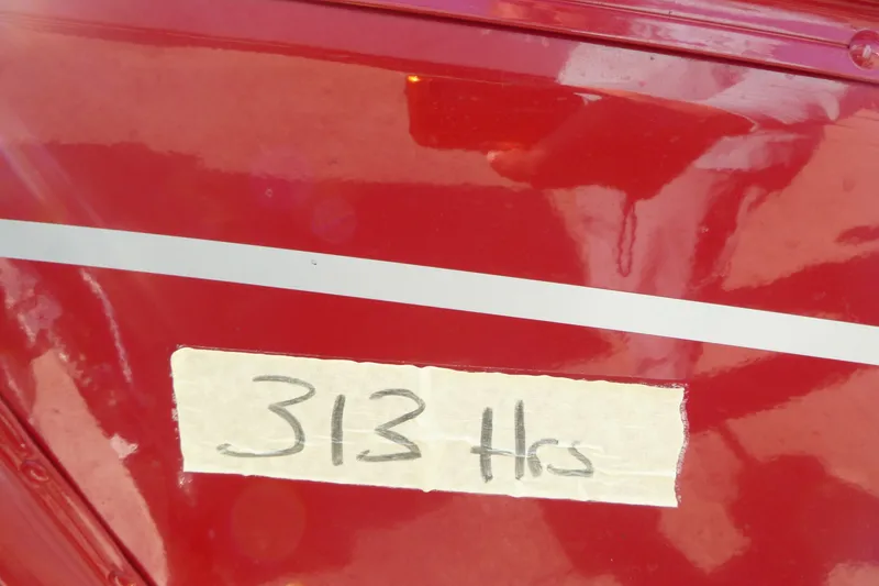 Slide: The Image of Red Lund 1650 Angler SS boat with "313 Hrs" written on tape. - 15