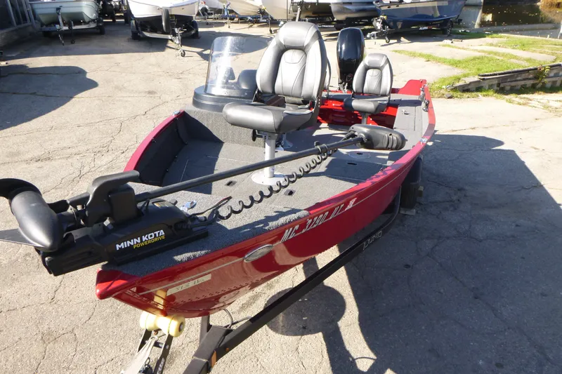 Slide: The Image of 2022 Lund 1650 Angler SS fishing boat with Minn Kota PowerDrive motor, parked outdoors. - 6