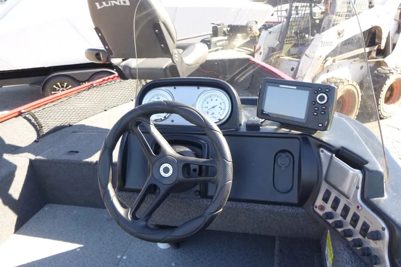 Slide: The Image of 2022 Lund 1650 Angler SS boat dashboard with steering wheel and navigation system. - 10