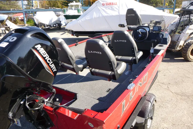 Slide: The Image of 2022 Lund 1650 Angler SS boat with Mercury engine, parked outdoors. - 12