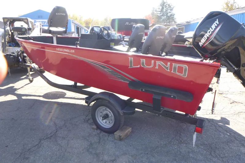 Slide: The Image of Red 2022 Lund 1650 Angler SS boat on trailer with Mercury engine. - 4