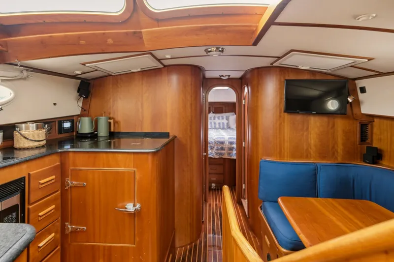Slide: The Image of Interior of 2002 Hinckley Talaria 44 Flybridge with wood finish and blue seating. - 27