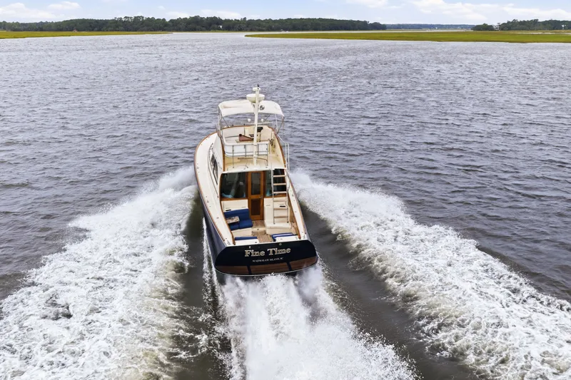 Slide: The Image of Hinckley Talaria 44 Flybridge 2002 cruising on open water, rear view. - 48