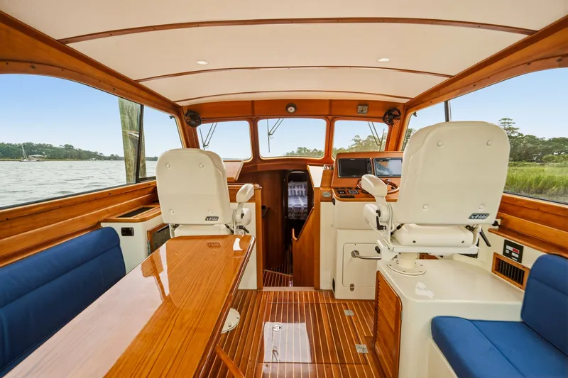 Slide: The Image of Interior of 2002 Hinckley Talaria 44 Flybridge with elegant wood finish and seating. - 26