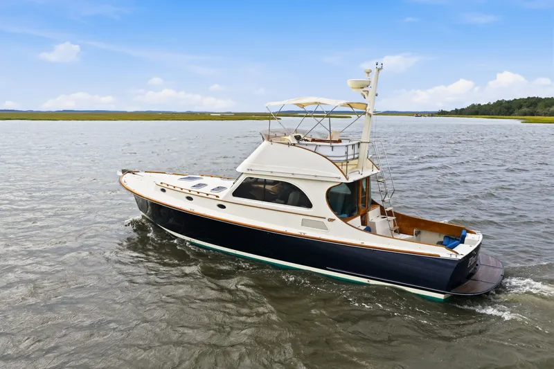 Slide: The Image of 2002 Hinckley Talaria 44 Flybridge yacht cruising on open water. - 1