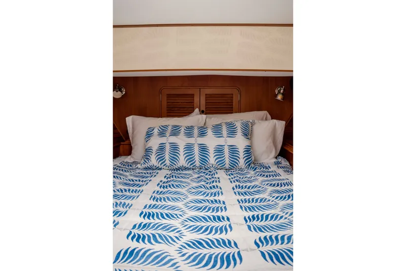 Slide: The Image of Cozy bed with blue leaf-patterned bedding on 2002 Hinckley Talaria 44 Flybridge yacht. - 37