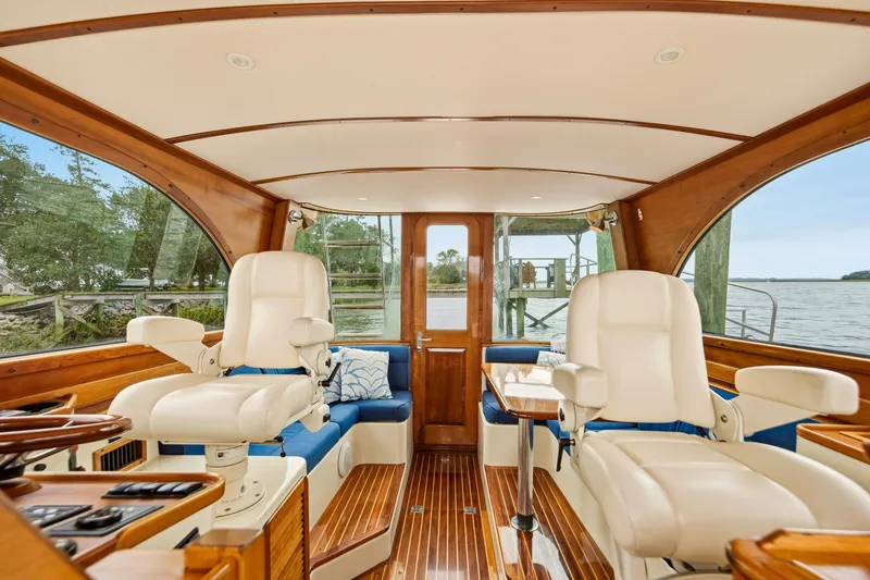 Slide: The Image of Interior of 2002 Hinckley Talaria 44 Flybridge yacht with luxurious seating and wooden finishes. - 15