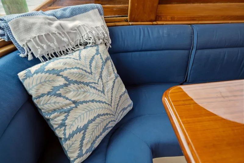 Slide: The Image of Cozy interior of 2002 Hinckley Talaria 44 Flybridge with blue seating and decorative pillow. - 12