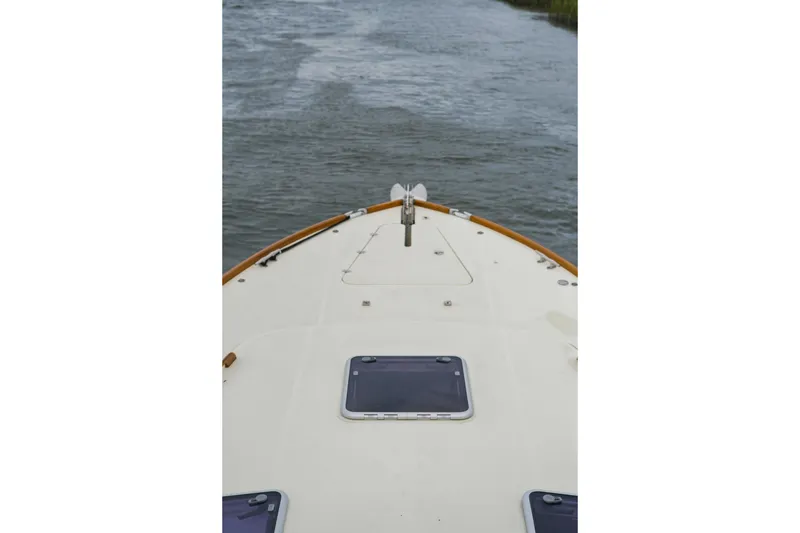 Slide: The Image of Bow view of 2002 Hinckley Talaria 44 Flybridge on water. - 40