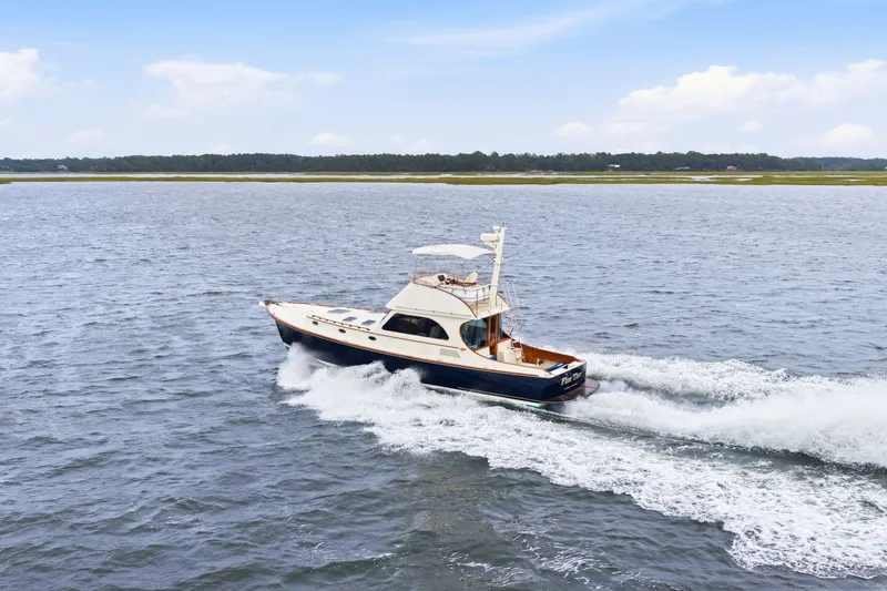 Slide: The Image of 2002 Hinckley Talaria 44 Flybridge cruising on open water. - 47