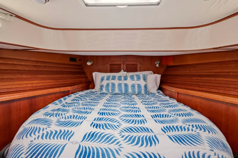 Slide: The Image of Cozy cabin interior of 2002 Hinckley Talaria 44 Flybridge with patterned bedding. - 36