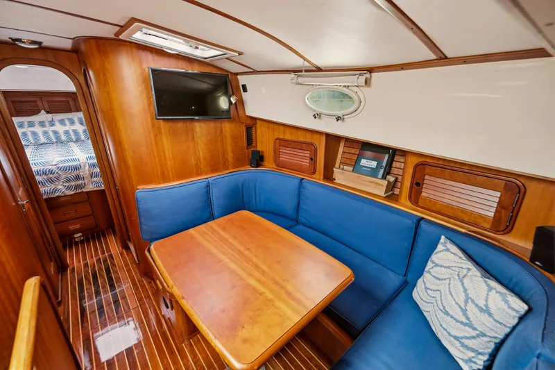 Slide: The Image of Luxurious 2002 Hinckley Talaria 44 Flybridge interior with blue seating and wooden accents. - 33