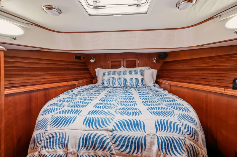 Slide: The Image of Cozy cabin interior of 2002 Hinckley Talaria 44 Flybridge with patterned bedding. - 35