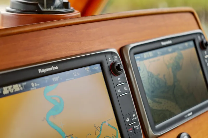 Slide: The Image of Hinckley Talaria 44 Flybridge 2002 dashboard with Raymarine navigation displays. - 22