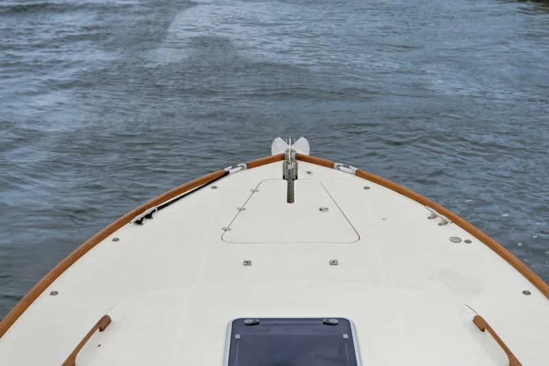 Slide: The Image of Bow view of 2002 Hinckley Talaria 44 Flybridge cruising on water. - 41