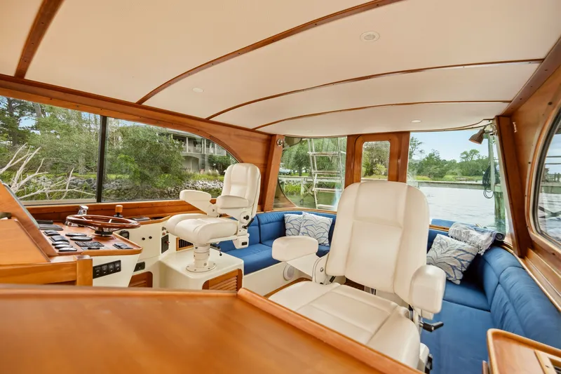 Slide: The Image of Interior of 2002 Hinckley Talaria 44 Flybridge with white seats and blue sofa. - 16