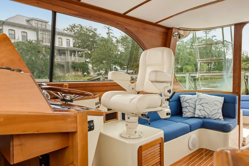 Slide: The Image of Interior of 2002 Hinckley Talaria 44 Flybridge with helm seat and blue seating. - 19
