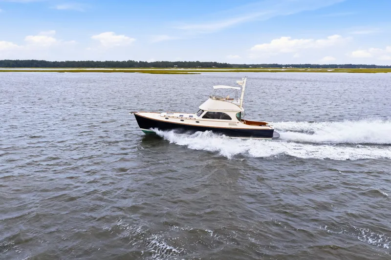 Slide: The Image of Hinckley Talaria 44 Flybridge 2002 cruising on open water under a clear sky. - 42