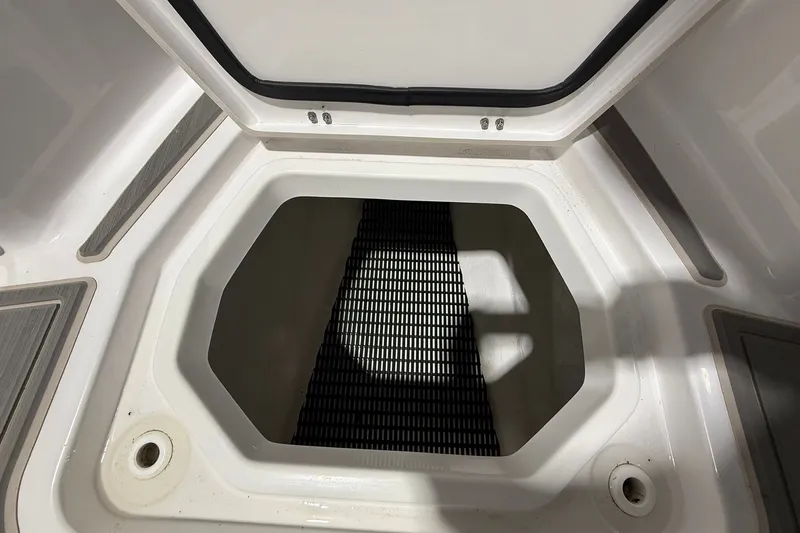 Slide: The Image of Storage compartment of 2025 Monterey Elite 27 OB boat, open lid view. - 38