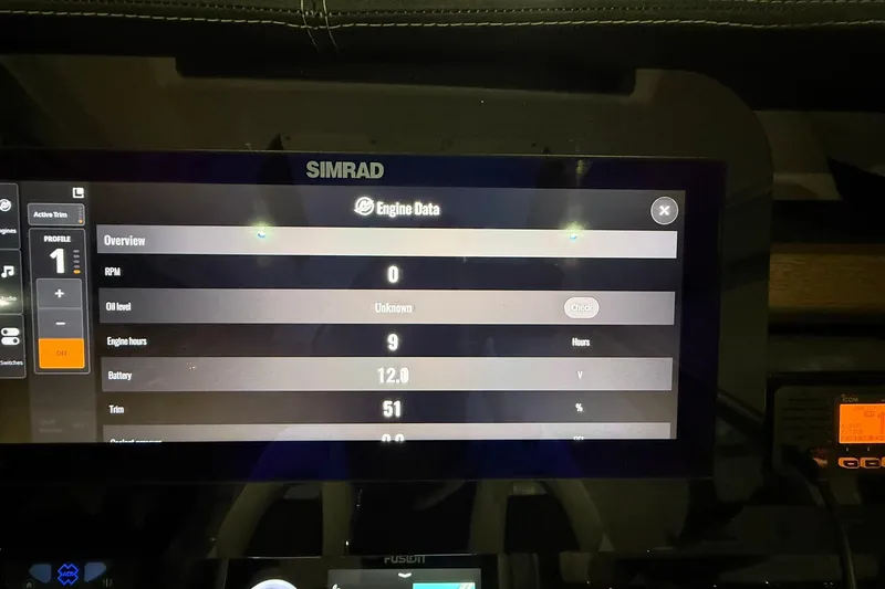 Slide: The Image of Simrad display showing engine data on a 2025 Monterey Elite 27 OB boat. - 24