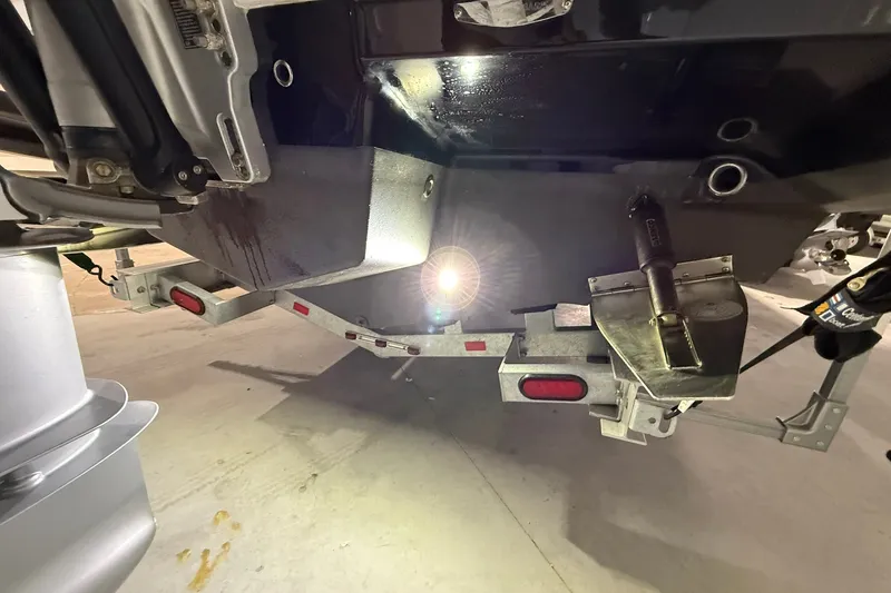 Slide: The Image of Underneath view of a 2025 Monterey Elite 27 OB boat on a trailer. - 47