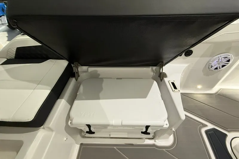 Slide: The Image of 2025 Monterey Elite 27 OB boat interior with open storage compartment and cushioned seating. - 14