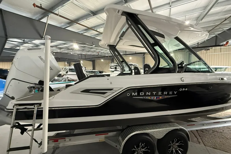 The Image of 2025 Monterey Elite 27 OB boat in showroom, featuring sleek design and powerful outboard motor. - 0