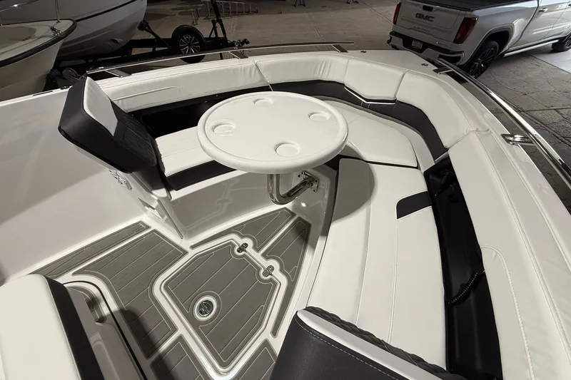 Slide: The Image of Luxurious seating area on 2025 Monterey Elite 27 OB boat with round table. - 43