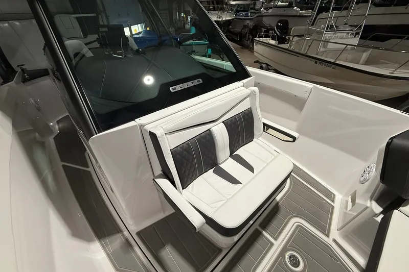 Slide: The Image of 2025 Monterey Elite 27 OB boat interior with cushioned seating and modern design. - 31