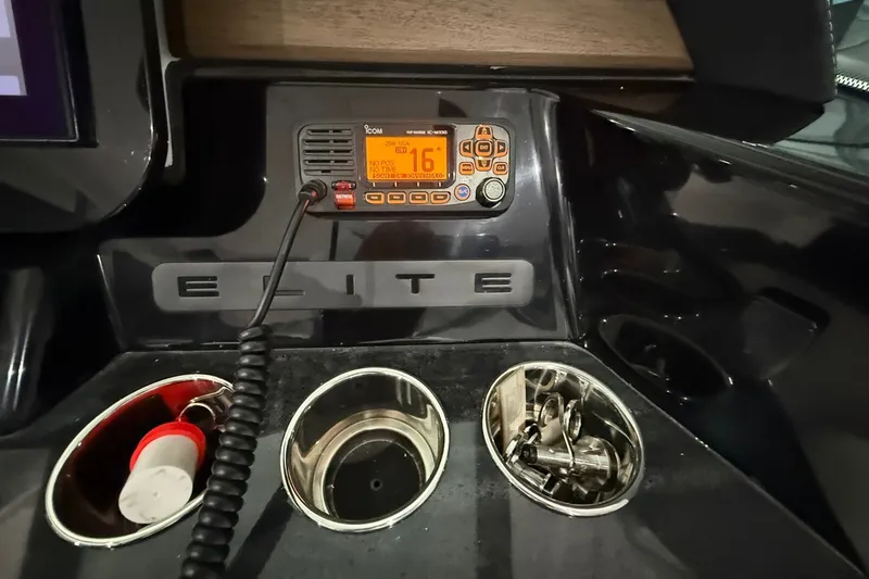 Slide: The Image of 2025 Monterey Elite 27 OB dashboard with radio and cup holders. - 23