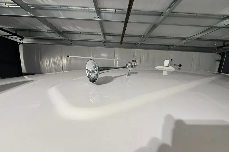 Slide: The Image of 2025 Monterey Elite 27 OB boat roof with chrome horn in a garage setting. - 45