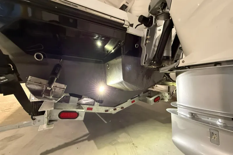 Slide: The Image of 2025 Monterey Elite 27 OB boat trailer with illuminated undercarriage detail. - 46