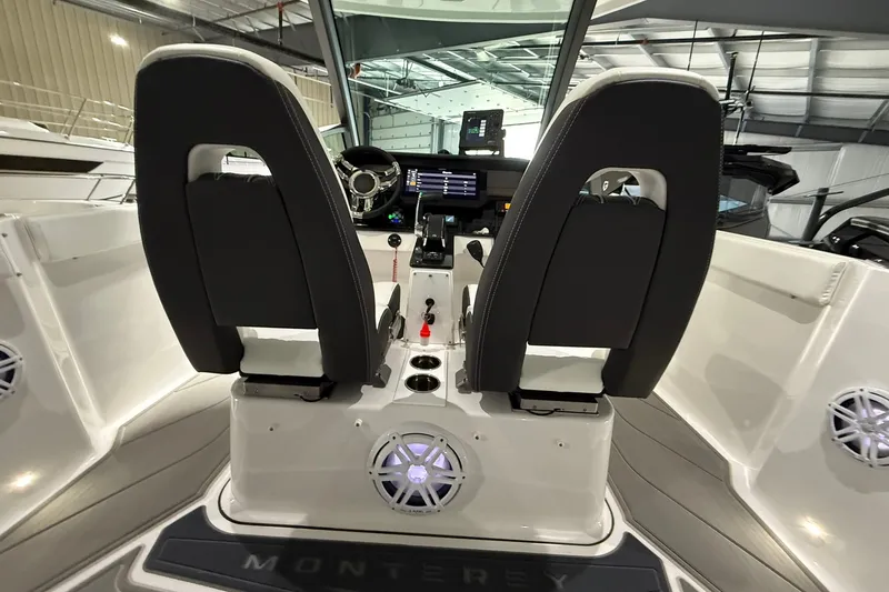 Slide: The Image of Interior view of 2025 Monterey Elite 27 OB boat cockpit with dual seats and control panel. - 18