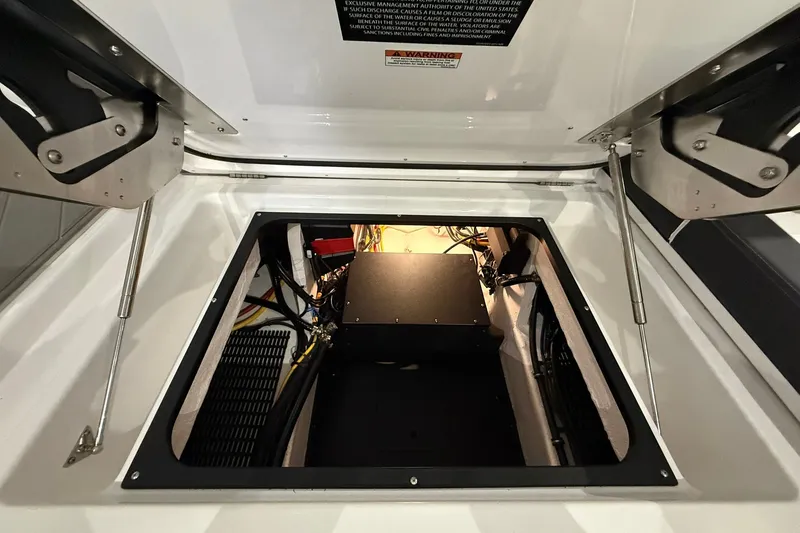 Slide: The Image of Open engine compartment of 2025 Monterey Elite 27 OB boat, showcasing internal components. - 13