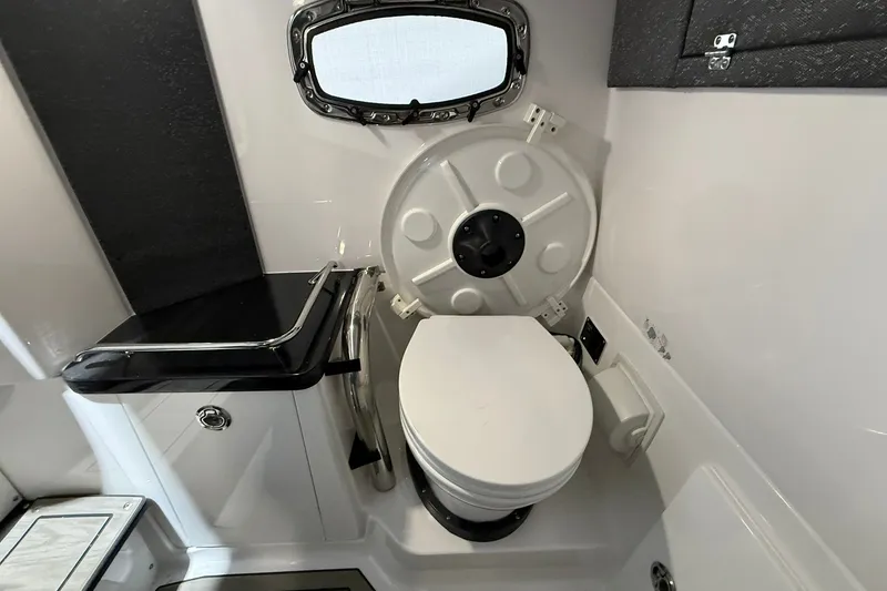 Slide: The Image of 2025 Monterey Elite 27 OB boat bathroom with compact toilet and sleek design. - 41