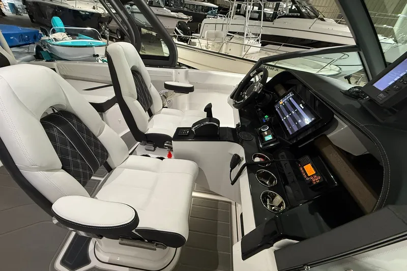 Slide: The Image of 2025 Monterey Elite 27 OB boat interior with modern dashboard and luxurious seating. - 19